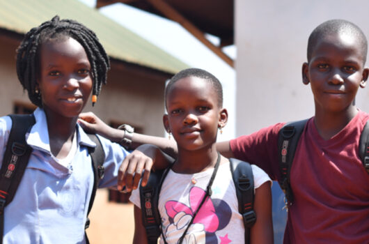 Three students smiling