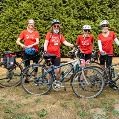 four women posing with their bikes
