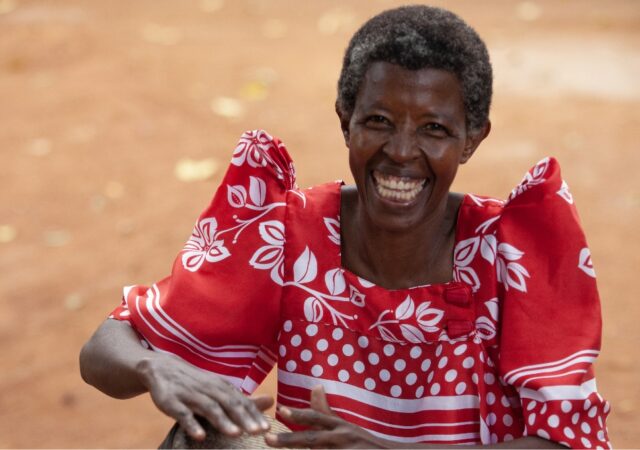 woman in a red dress with a bright smile