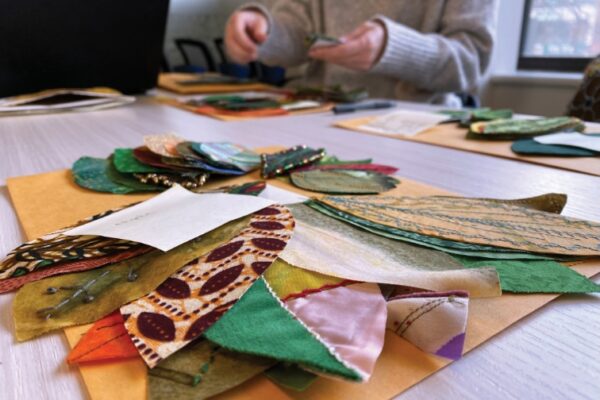 pieces of fabric cut in leaf shapes on a table