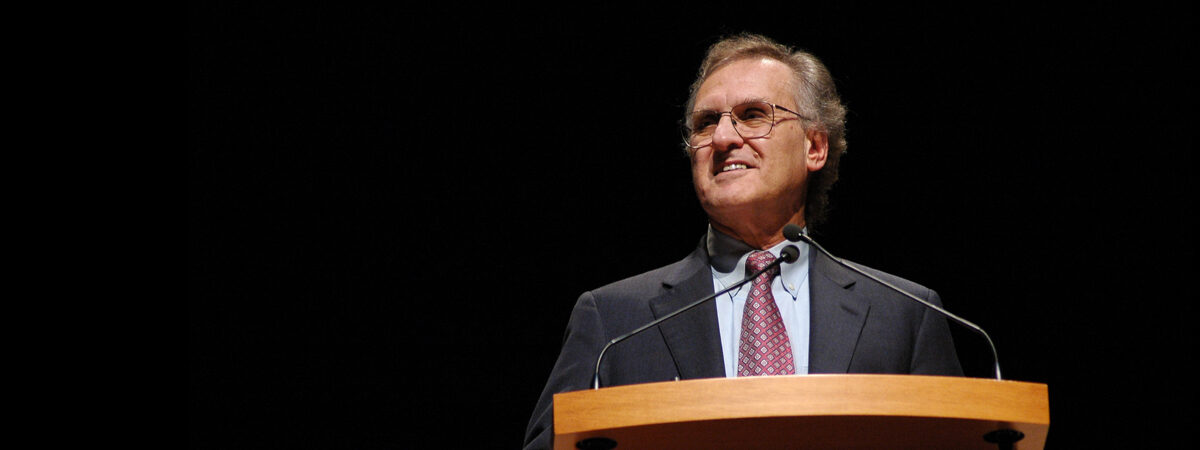 Stephen Lewis speaking at a podium.