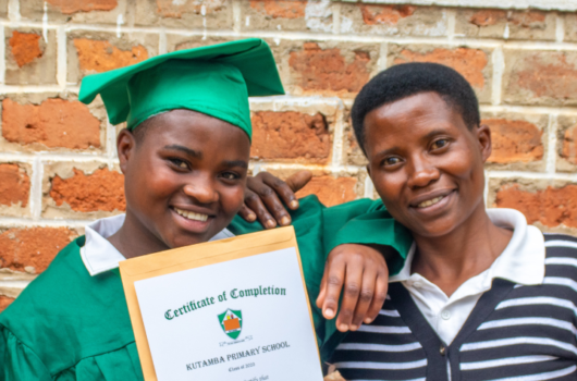 Angella and her mother on her graduation day at Kutumba School, part of Nyaka in Uganda.